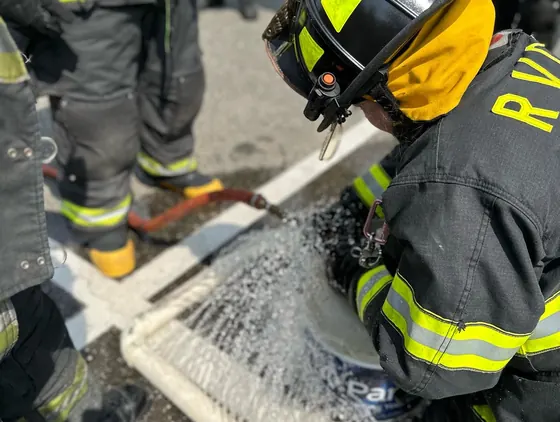 Woodland members flowing water during a daytime drill